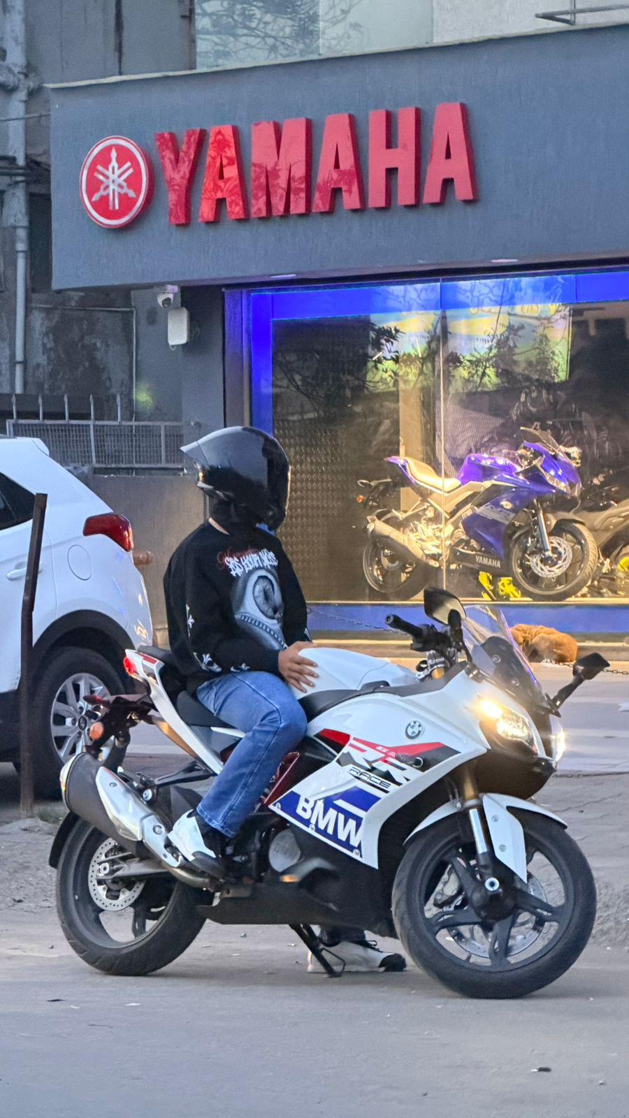 Dhruv Shukla wearing a helmet and seated on his motorcycle