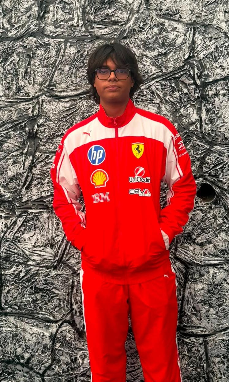 Dhruv Shukla wearing a red motorsport tracksuit